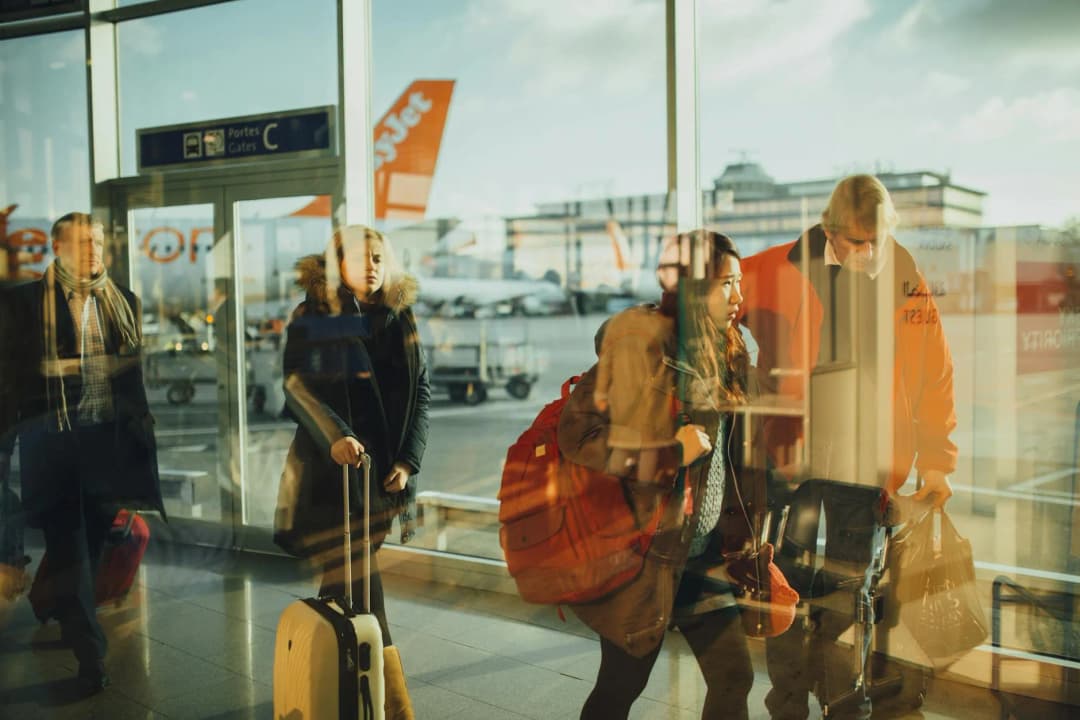 Airport gate with passengers and airplanes